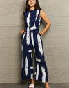 Perfee Printed Round Neck Cutout Jumpsuit with Pockets