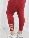 Yelete Ready For Action Full Size Ankle Cutout Active Leggings in Brick Red